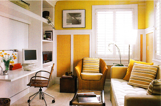 Home office in golden tones with wicker furniture and built-in workspace..